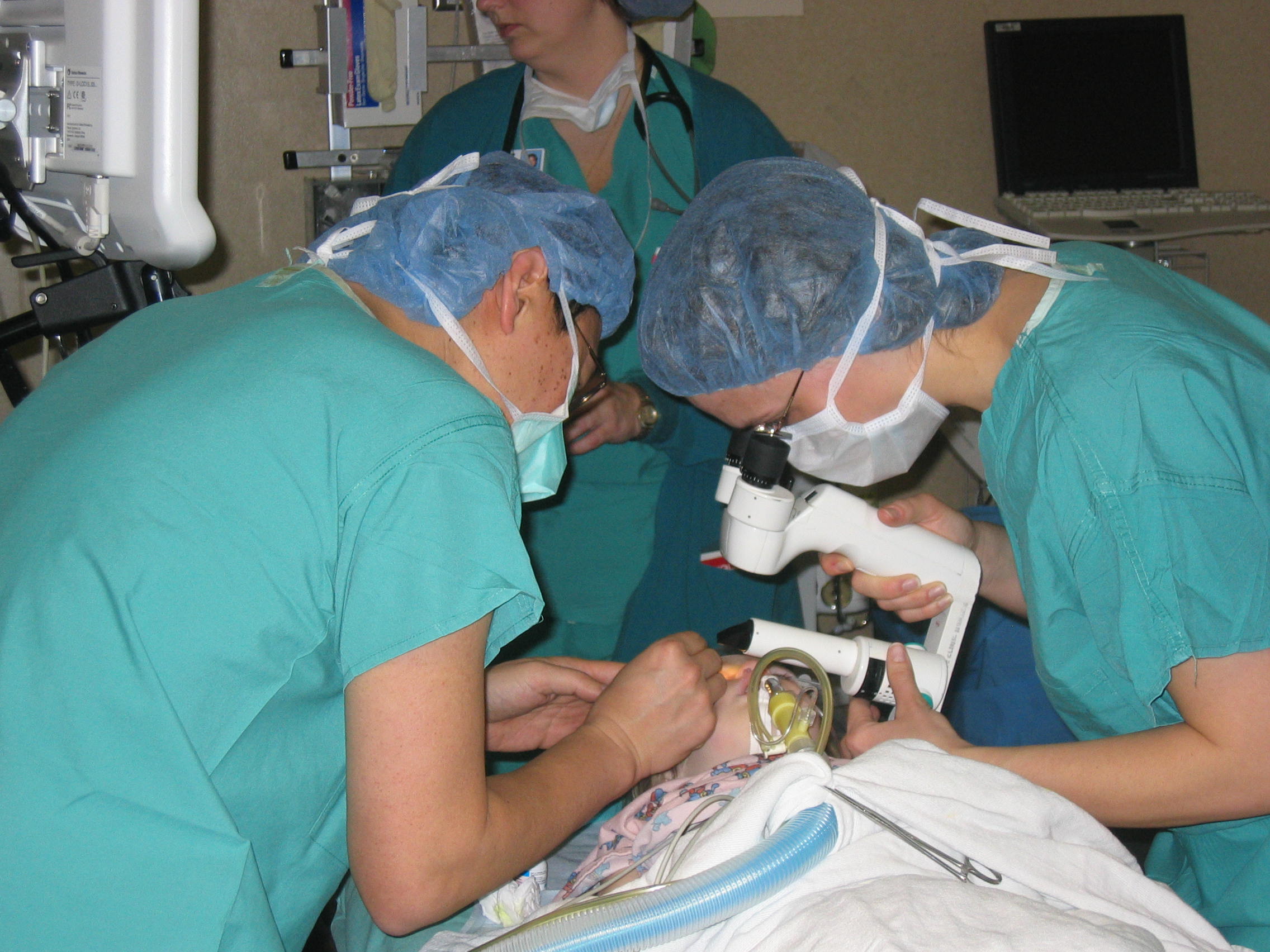 doctors exming glaucoma patient under anesthesia